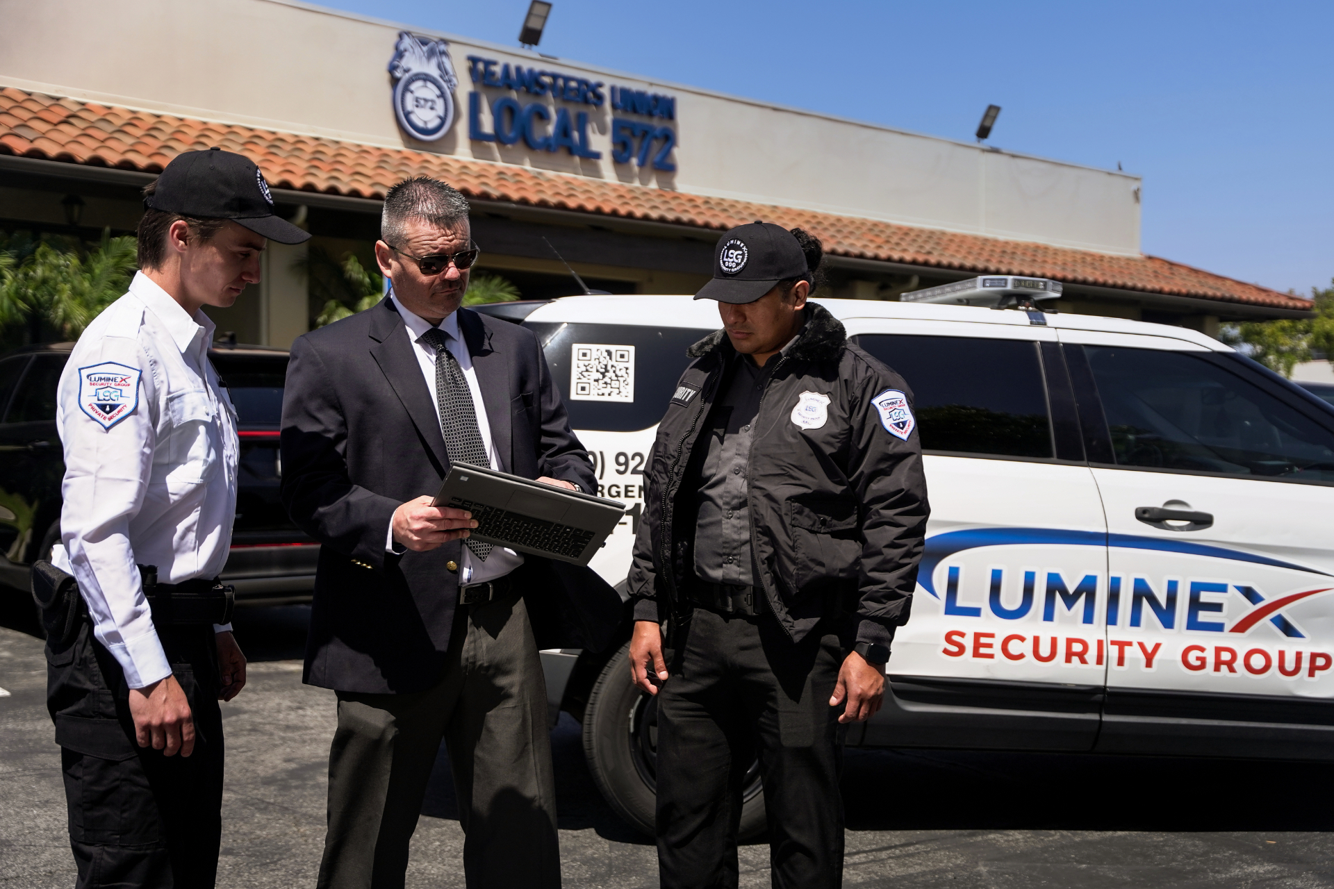 Luminex supervisor briefing two officers in front of marked patrol vehicle