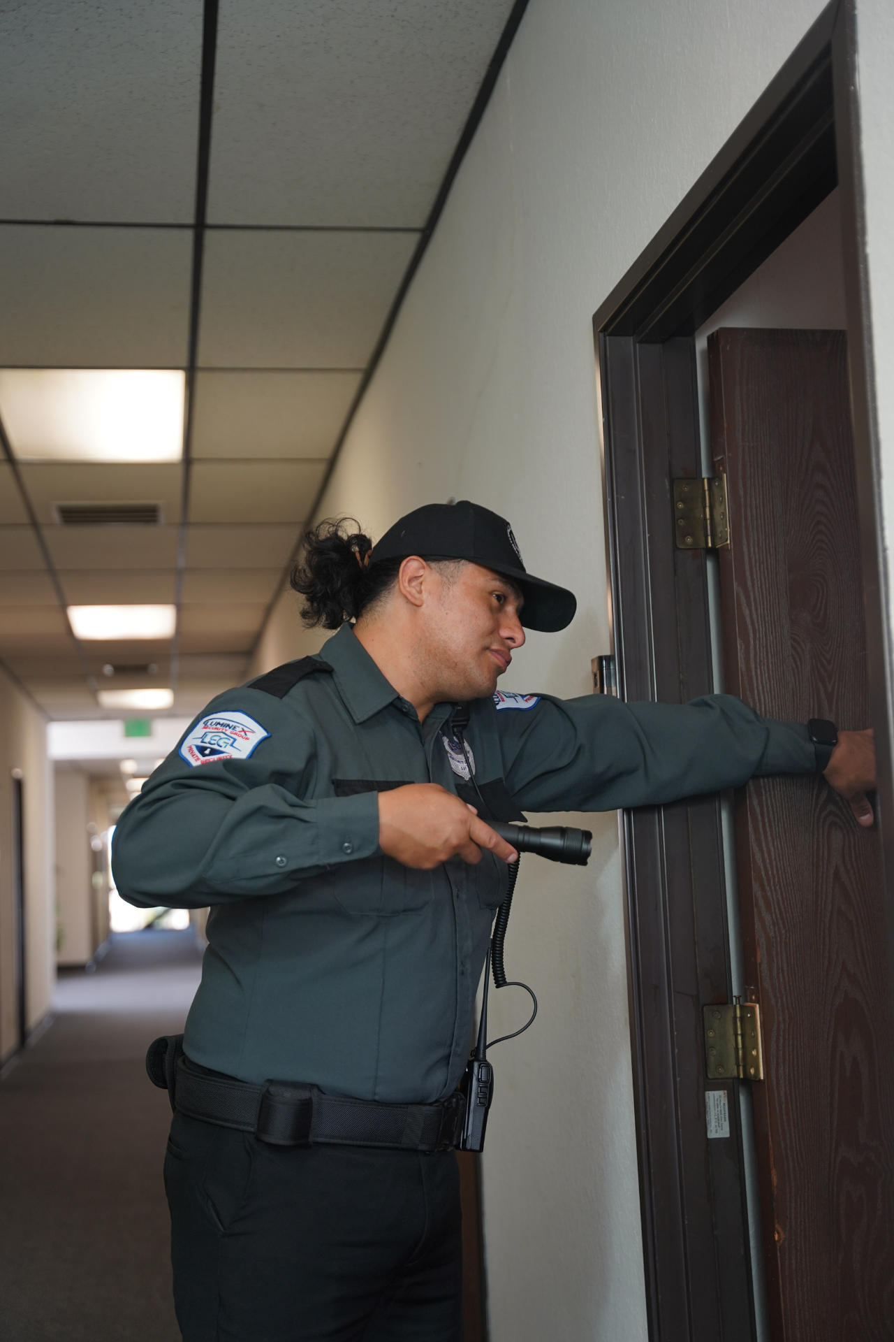 Luminex officer performing an interior door check during a patrol round