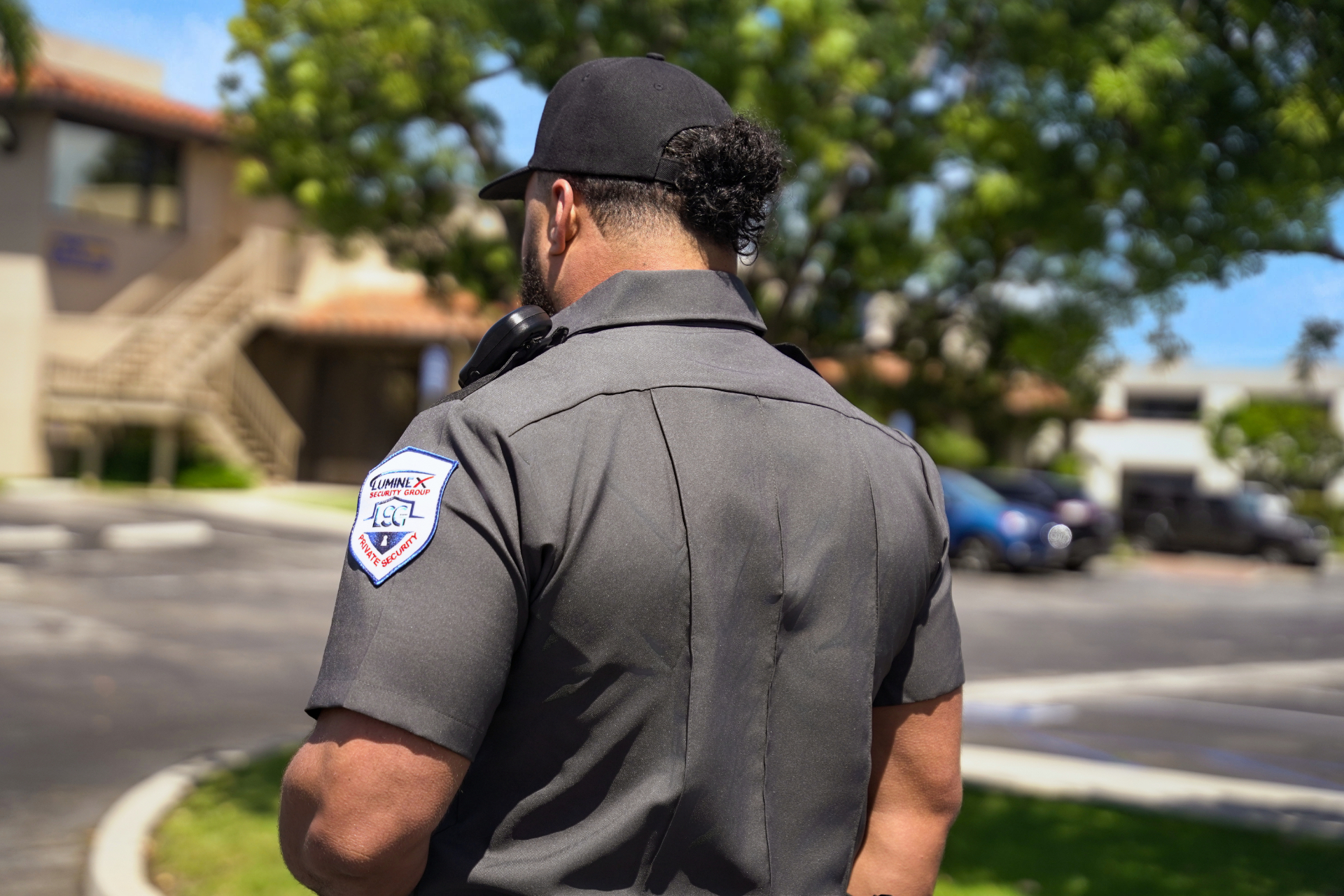 Luminex officer on post, shoulder patch visible
