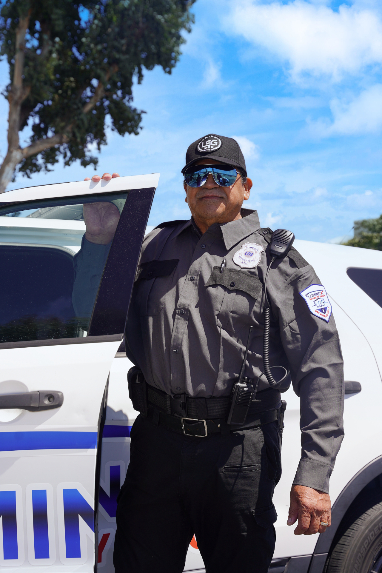 Luminex patrol officer stepping out beside a marked patrol vehicle