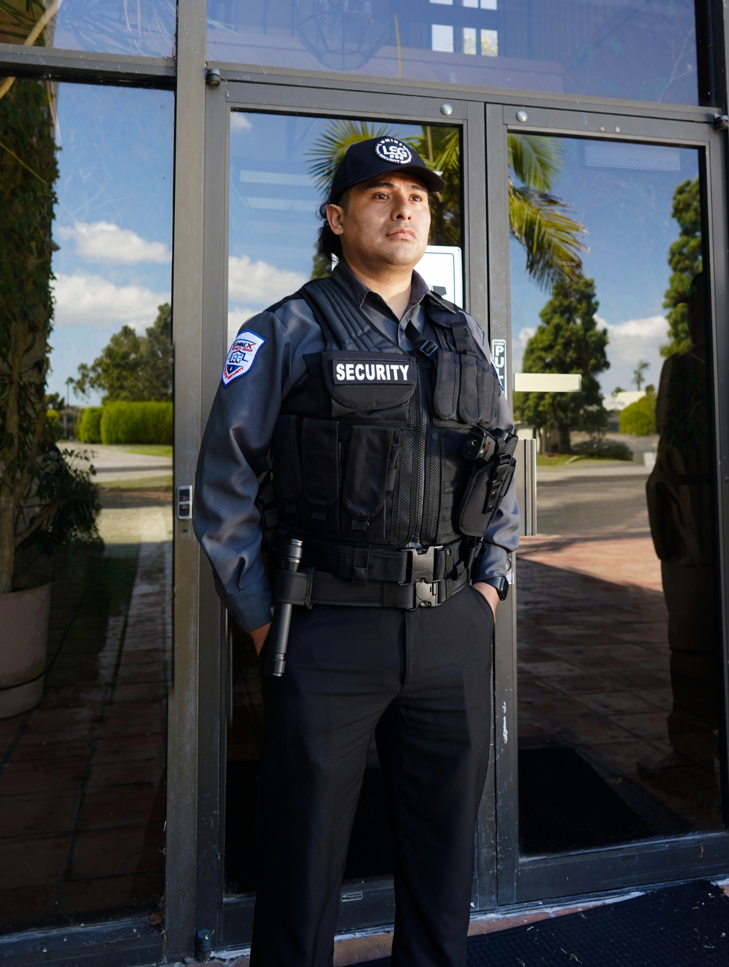 Luminex tactical officer in vested uniform standing at a glass entrance