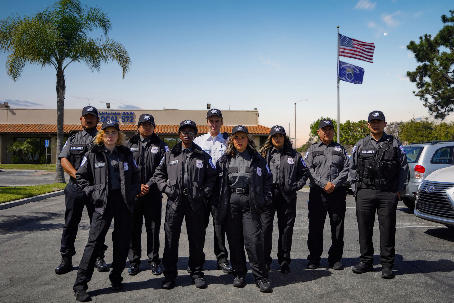 Luminex Security Group officer team in formation outside Teamsters Local 572 with American flag