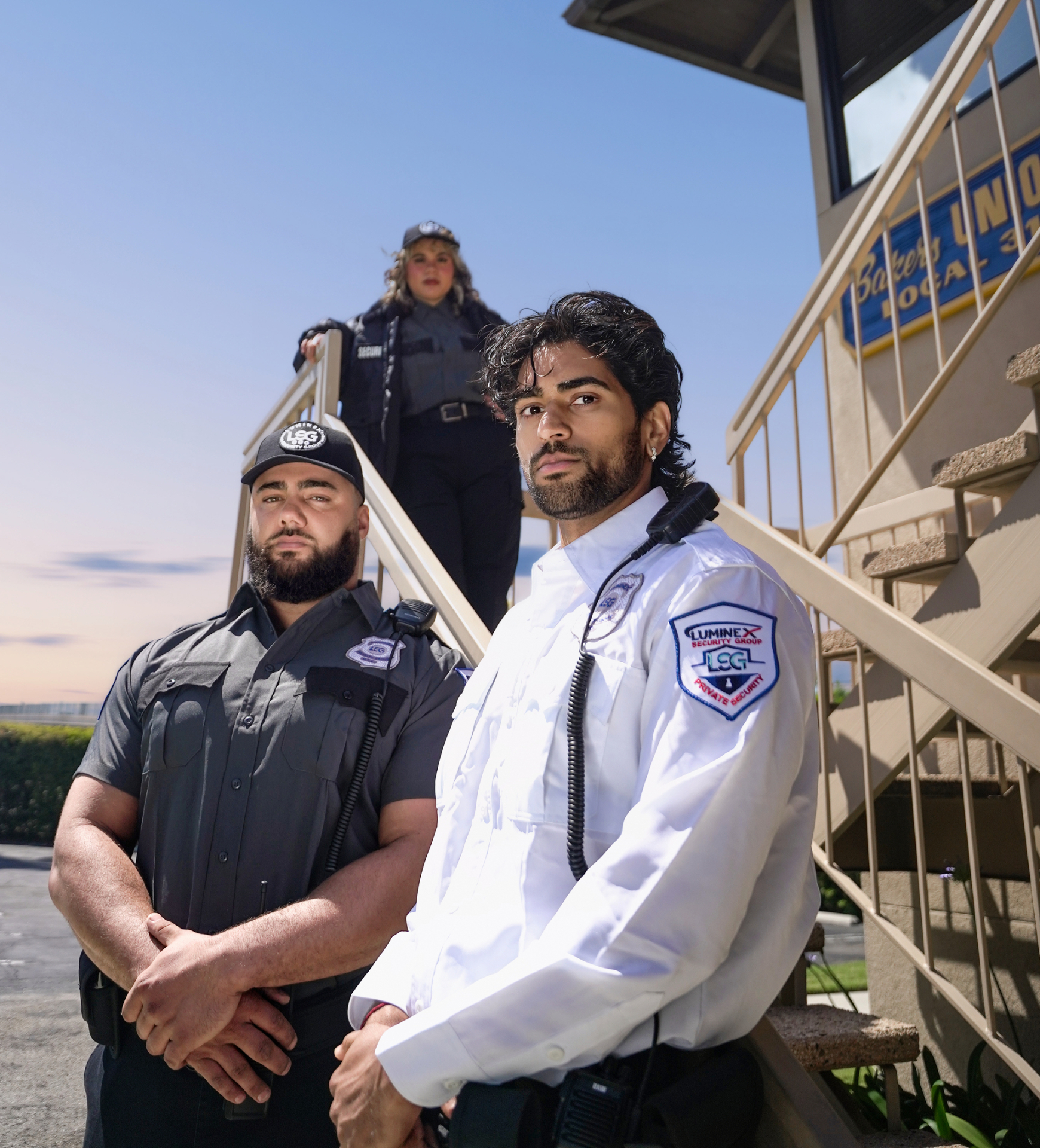 Luminex three-officer team posed across an exterior stair formation